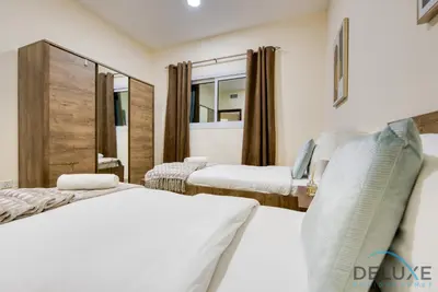 a hotel room with two beds and a mirror at Next to Lake 2BR Apartment Accessible to Metro, Dubai Gate 2, Jumeirah Lake Towers by Deluxe Holiday Homes in Dubai