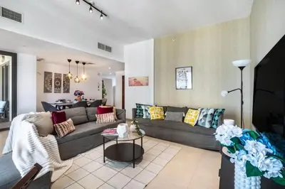 a living room with a couch and a table at The Smart Concierge - Bahar 1 in Dubai