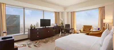 a hotel room with a bed and a large window at Conrad Dubai in Dubai