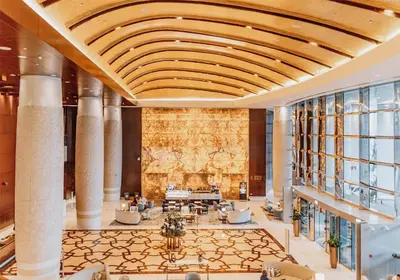 a lobby of a hotel with a map on the wall at Conrad Dubai in Dubai