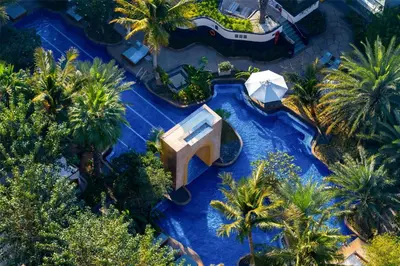 an overhead view of a water park with palm trees at Conrad Dubai in Dubai