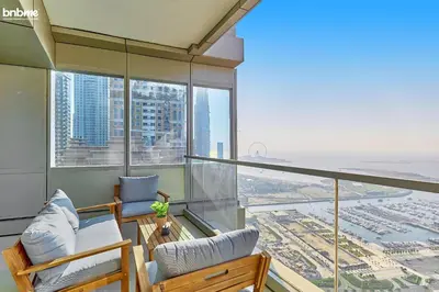 an apartment balcony with views of the city at bnbme - Dubai Marina 54th Floor Apt Sea View Two Balconies Pool Gym & Parking in Dubai