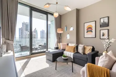 a living room with a couch and a table at GuestReady Holiday Homes - A Sigh of Bliss in Dubai