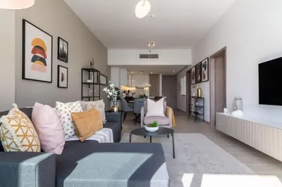 a living room with a couch and a tv at GuestReady Holiday Homes - A Sigh of Bliss in Dubai