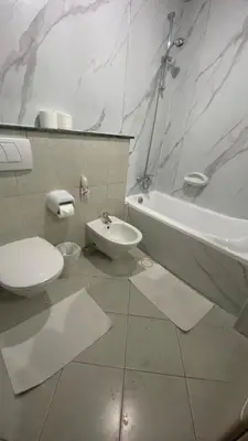 a bathroom with a toilet and a sink and a tub at skynest homes studio in JLT in Dubai