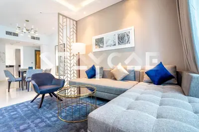 a living room with a couch and a table at Staycae Holiday Homes - Prive in Dubai