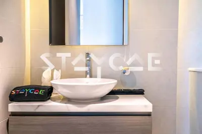 a bathroom with a white sink and a mirror at Staycae Holiday Homes - Prive in Dubai