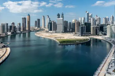 a view of a river in a city with buildings at The Smart Concierge - Damac Maison Prive in Dubai