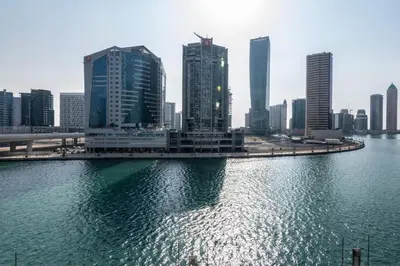a city with tall buildings and a body of water at The Smart Concierge - Damac Maison Prive in Dubai