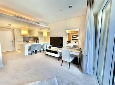a kitchen and dining room with a table and chairs at Fashion Avenue Dubai Mall Residences - Studio with balcony in Dubai