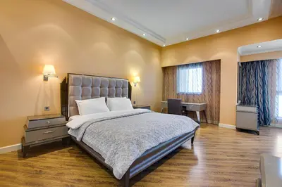 a bedroom with a large bed and a desk at Stunning 2BD sea view apartment in Jbr in Dubai