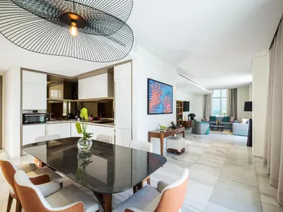 a dining room and kitchen with a table and chairs at Th8 Palm Dubai Beach Resort, Vignette Collection by IHG in Dubai
