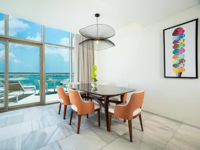 a dining room with a table and chairs at Th8 Palm Dubai Beach Resort, Vignette Collection by IHG in Dubai