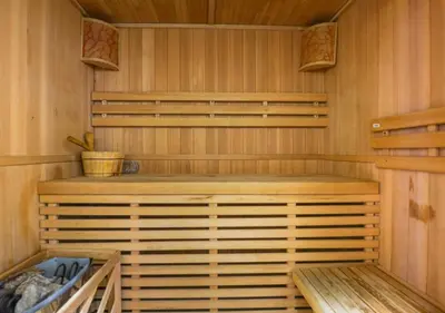 a sauna with a bench in a wooden cabin at City Stay Residences - Serviced Apartments Al Barsha in Dubai