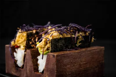 a pile of food sitting on top of a wooden block at Radisson Dubai Damac Hills in Dubai