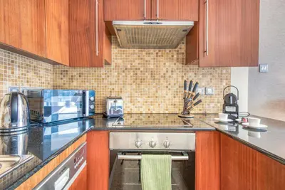 a kitchen with a sink and a stove top oven at Prime Retreats - Downtown Dubai in Dubai