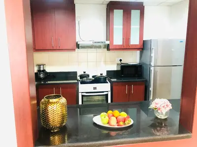 a kitchen with a plate of fruit on a counter at Luxury Casa - Royal Sea View Apartment JBR Beach 2BR in Dubai