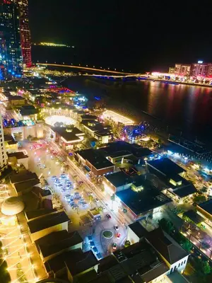 an aerial view of a city at night at Luxury Casa - Royal Sea View Apartment JBR Beach 2BR in Dubai