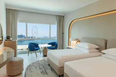a hotel room with two beds and a view at Sheraton Jumeirah Beach Resort in Dubai