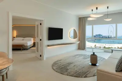 a hotel room with a bed and a television at Sheraton Jumeirah Beach Resort in Dubai