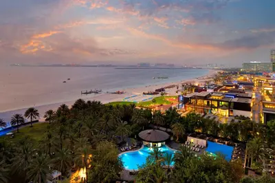 an aerial view of a beach at dusk at Sheraton Jumeirah Beach Resort in Dubai