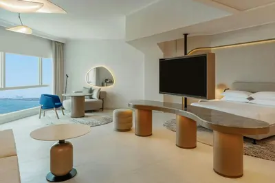 a hotel room with a bed and a desk at Sheraton Jumeirah Beach Resort in Dubai