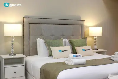 a bedroom with a large bed with towels on it at HiGuests - Fabulous Duplex With Breathtaking Lake Views in Dubai