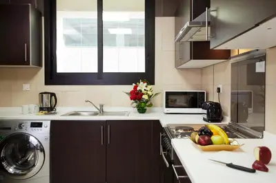 a kitchen with a sink and a counter with fruit on it at Al Waleed Holiday Homes in Dubai