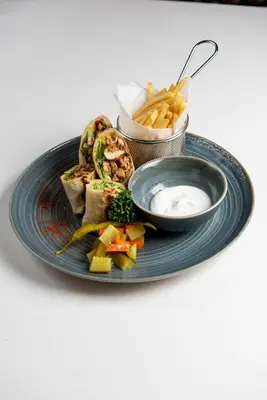 a blue plate of food with french fries and dip at ABAR HOTEL APARTMENTS DIP-1 in Dubai