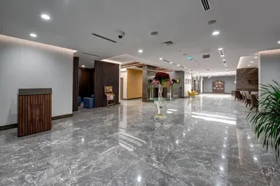 a lobby of a hotel with a marble floor at ABAR HOTEL APARTMENTS DIP-1 in Dubai