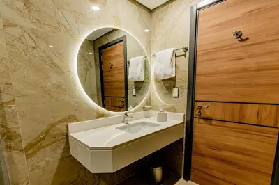 a bathroom with a sink and a mirror at Resivation Hotel in Dubai