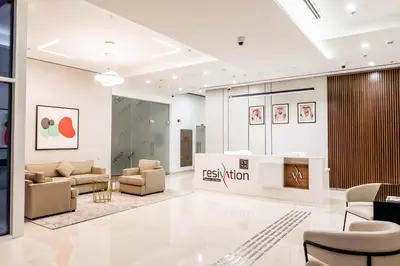 a lobby of a store with couches and chairs at Resivation Hotel in Dubai