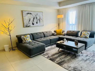 a living room with a couch and a table at Balqis Residense Palm Jumeirah,Pool, Beach, Top floor, Full sea view, Restaurants in Dubai