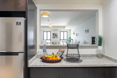 a bowl of fruit on a counter in a kitchen at Balqis Residense Palm Jumeirah,Pool, Beach, Top floor, Full sea view, Restaurants in Dubai