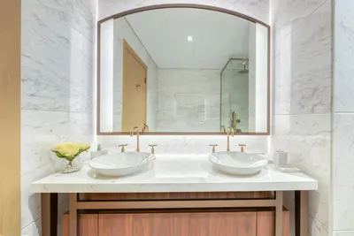 a bathroom with two sinks and a large mirror at RH- A Stylish Home Away from Home, Spacious 02 BR near Dubai Mall in Dubai