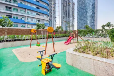 a playground with two swings and a slide at RH- A Stylish Home Away from Home, Spacious 02 BR near Dubai Mall in Dubai
