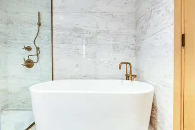 a white tub in a bathroom with a shower at RH- Upscale Living in the Heart of the City, 02BR, Near Dubai Mall in Dubai