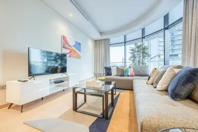 a living room with a couch and a tv at RH- Upscale Living in the Heart of the City, 02BR, Near Dubai Mall in Dubai