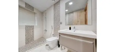 a bathroom with a toilet and a sink and a shower at Luxurious 4-Bedroom Duplex VILLA Apartment near JBR in Dubai