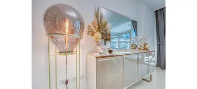 a room with a mirror and a dresser with a lamp at Luxurious 4-Bedroom Duplex VILLA Apartment near JBR in Dubai