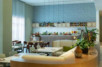 a restaurant with tables and chairs and a kitchen at Element Al Mina, Dubai Jumeirah in Dubai