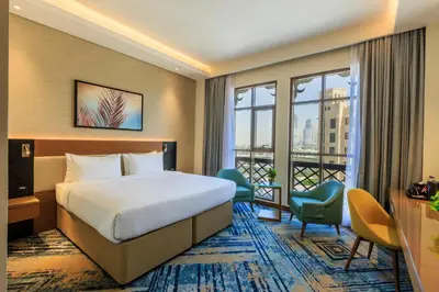 a hotel room with a bed and a balcony at S19 Hotel-Al Jaddaf Metro Station in Dubai