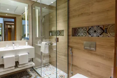 a bathroom with a glass shower and a sink at S19 Hotel-Al Jaddaf Metro Station in Dubai