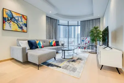 a living room with a couch and a table at RH- Downtown Delight, Chic 01BR near Dubai Mall & Burj Khalifa, RP Heights in Dubai