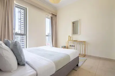 a bedroom with a large bed and a large window at Frank Porter - Mon Reve in Dubai