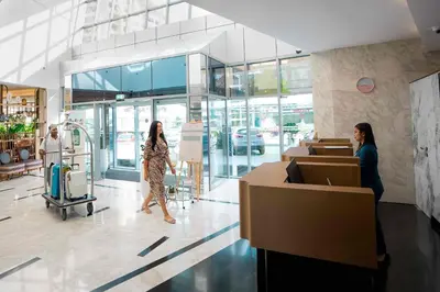 two women walking in a store lobby at Grand Heights Dubai Hotel Apartments in Dubai