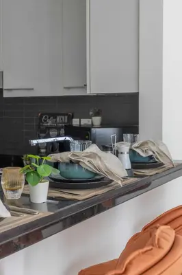 a kitchen counter with plates and utensils on it at Frank Porter - Silverene in Dubai
