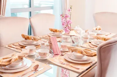 a table with white dishes and napkins on it at Elite Royal Apartment - Full Burj Khalifa & Fountain View - Brilliant - 2 bedrooms & 1 open bedroom without partition in Dubai