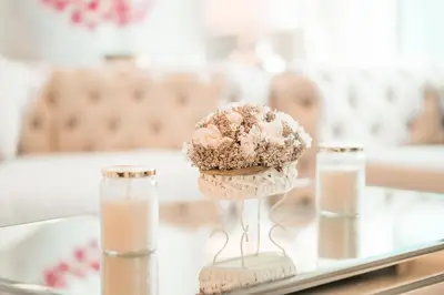 a cupcake on a glass table with two bottles of milk at Elite Royal Apartment - Full Burj Khalifa & Fountain View - Emerald in Dubai
