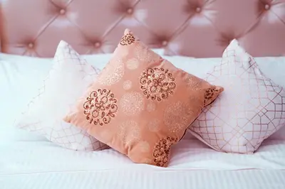 a group of pillows sitting on top of a bed at Elite Royal Apartment - Full Burj Khalifa & Fountain View - Emerald in Dubai